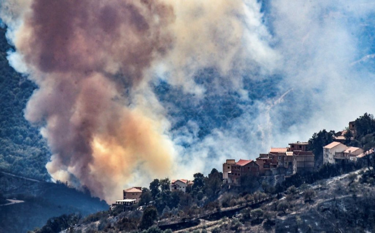 Heavy smoke rises during a wildfire in the forested hills of the Kabylie region, east of the Algerian capital Algiers