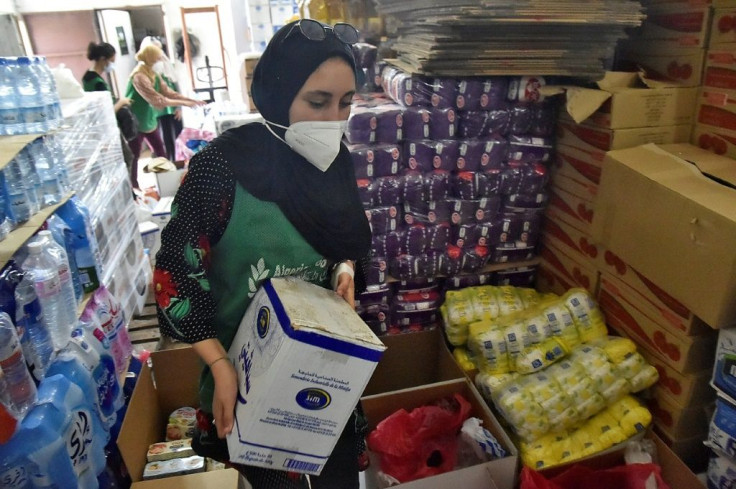 Volunteers of the SIDRA Association NGO take part in an initiative with the Algerian Food Bank to send aid packages to victims of the Kabylie region forest fires in Algeria's capital Algiers, on August 12, 2021