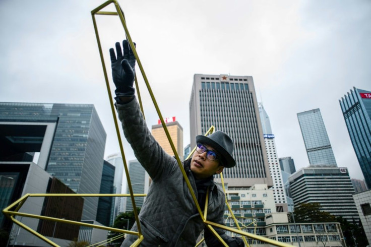 Wong poses in his sculpture 'Asteroids & Comets' in Hong Kong in 2018