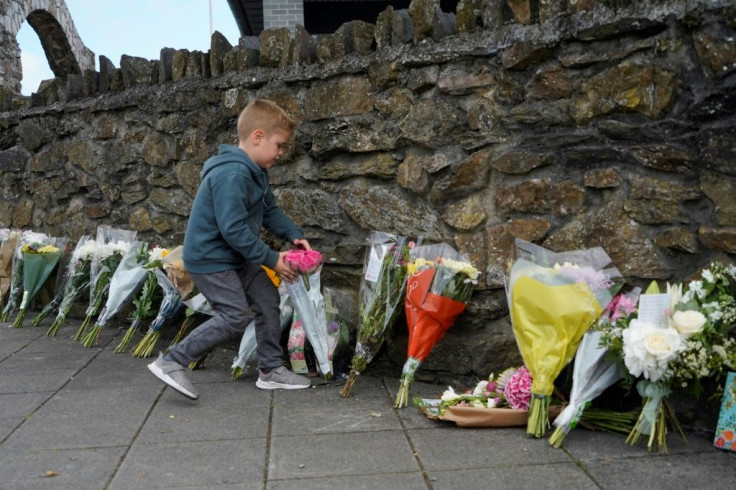 Floral tributes are placed near the scene of a shooting spree where five people died in Plymouth, southwest England