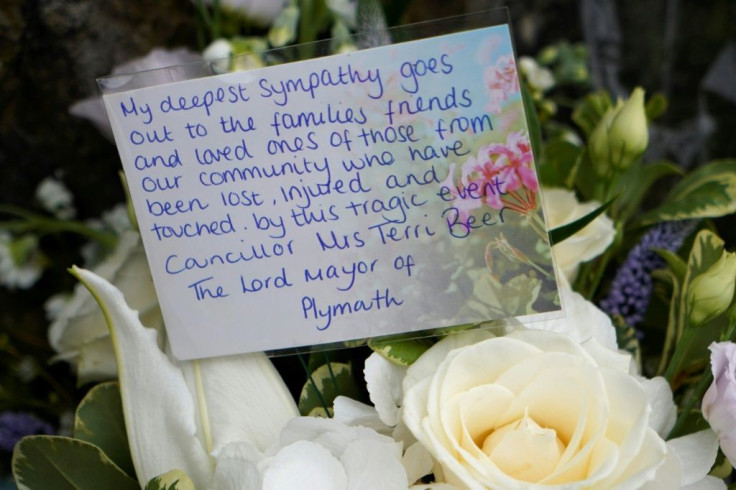 A floral tribute with a message from Terri Beer Lord Mayor of Plymouth is seen near where a troubled loner shot dead five people