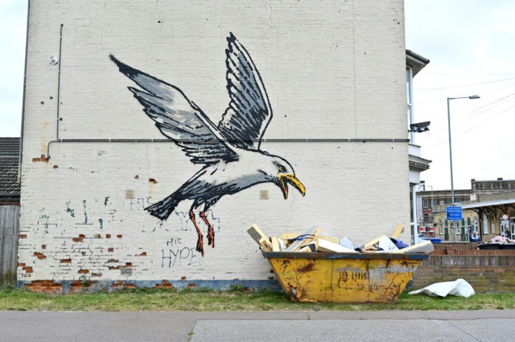 A seagull swoops down on some outsized chips in a waste skip -- both common sights in modern day Britain