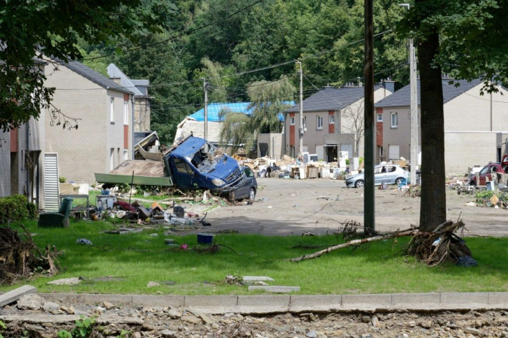 Flood-hit villages are still cluttered by smashed cars, uprooted trees and ruined furniture