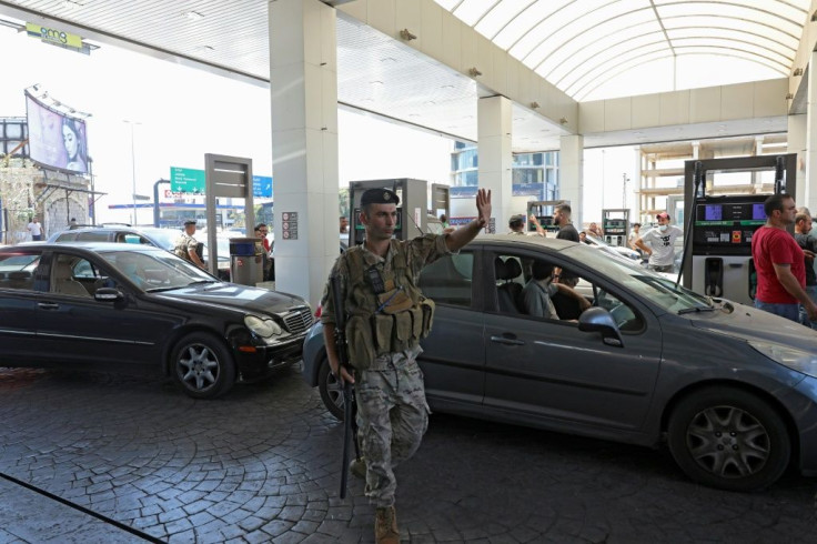 A Lebanese soldier directs traffic at a petrol station in the capital Beirut on Saturday, after soldiers were deployed to force several stations to reopen their doors
