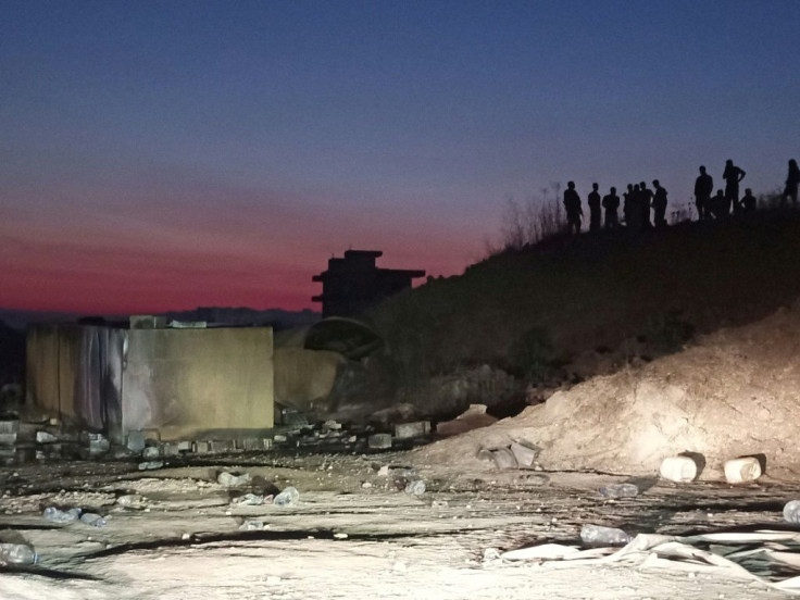 The site of the overnight fuel tank explosion in Lebanon's northern region of Akkar - the remains of the tank are visible to the left