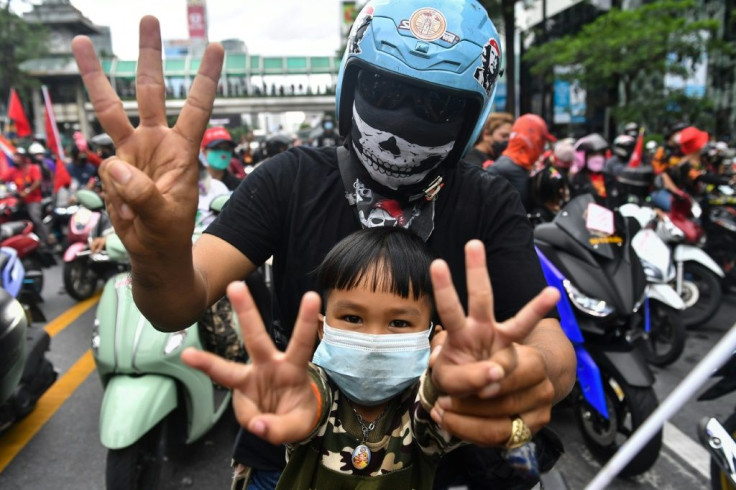 Protesters flashed the three-finger salute of resistance