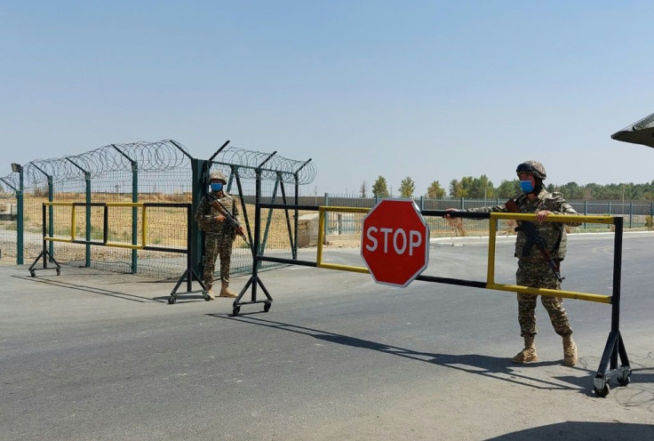 Uzbek soldiers guard a checkpoint, two kilometres from Friendship Bridge over the Amu Darya river, which separates Uzbekistan and Afghanistan near Termez