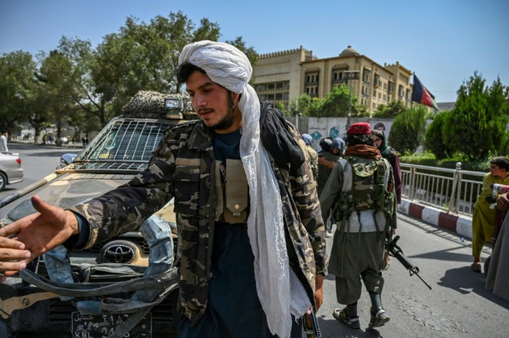 Taliban fighters stand guard in Kabul after their swift takeover of the Afghan capital
