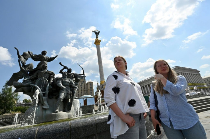 Belarusian journalist Anna Kaltygina (L) and PR manager Alexandra Pushkina stand on Kiev's Independence Square