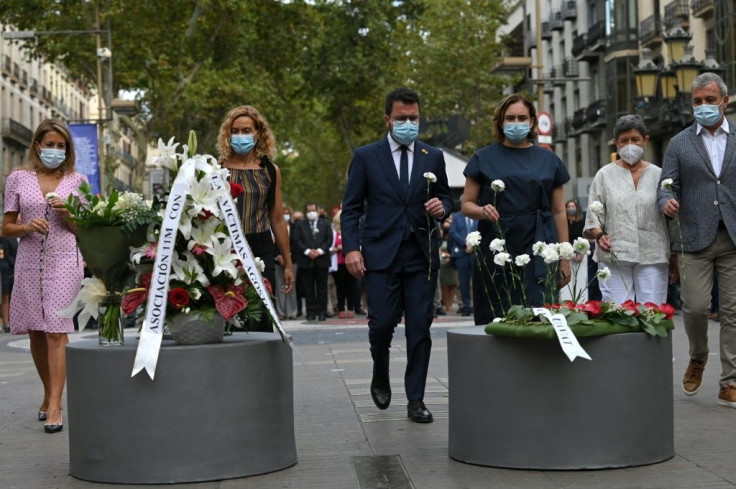 Dozens of people observed a minute's silence on Barcelona's Las Ramblas boulevard where on August 17, 2017 a van mowed down pedestrians leaving behind a trail of bodies