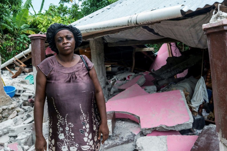 A woman in front of her home, devastated by Saturday's earthquake, in Camp Perrin, in HaÃ¯ti, le 16 aoÃ»t 2021
