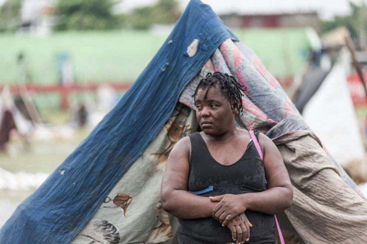 People gather after spending the night outside in the aftermath of the earthquake, facing the severe inclement weather of Tropical Storm Grace near Les Cayes, Haiti on August 17, 2021