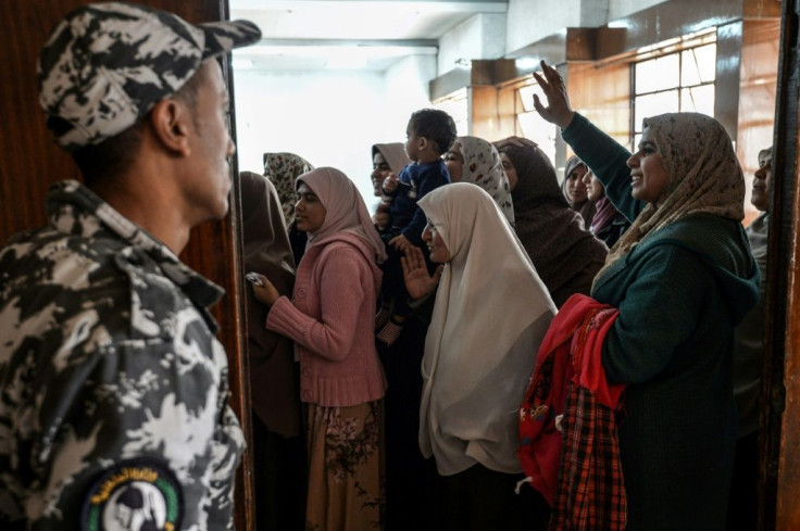 Relatives of Muslim Brotherhood members facing the death penalty try to wave to their loved ones at a hearing in December 2018