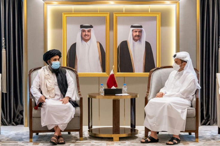 The Taliban's political office chief Mullah Abdul Ghani Baradar meets with Qatari Foreign Minister Sheikh Mohammed bin Abdulrahman Al-Thani in Doha in this handout picture provided by the Qatari foreign ministry on August 17, 2021
