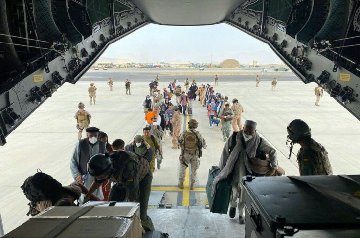 Spaniards and Afghans who worked with them board a Spanish Air Force plane to Dubai