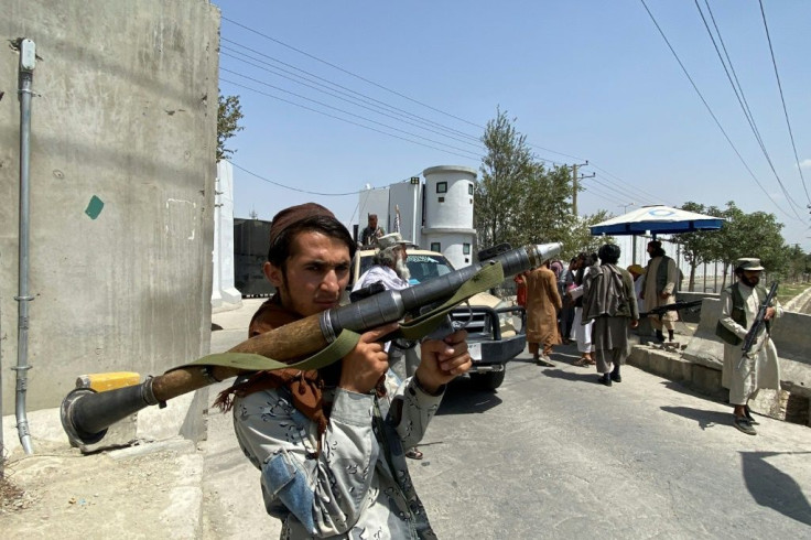 A Taliban fighter holds an RPG as he stands guard  outside the interior ministry in the Afghan capital Kabul