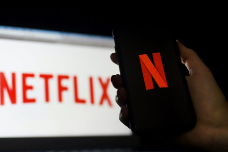 In this photo illustration a computer and a mobile phone screen display the Netflix logo in March 2020 in Arlington, Virginia