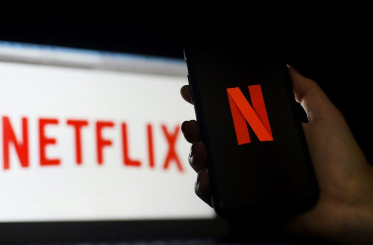 In this photo illustration a computer and a mobile phone screen display the Netflix logo in March 2020 in Arlington, Virginia