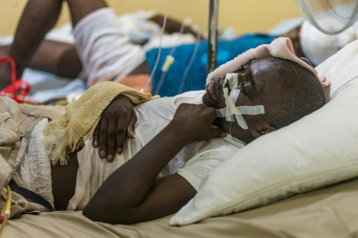 A young man injured by the earthquake lies on a bed at the "Communautaire de Référence" hospital in Port-Salut, Haiti