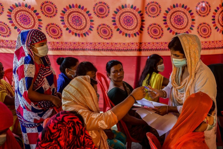 A health official registers the details of sex workers who gathered to get themselves inoculated in Daulatdia