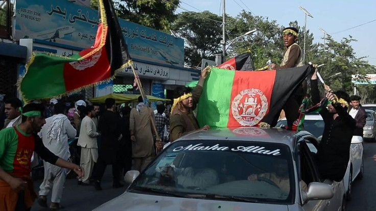 Protesters wave Afghan flags at scattered rallies to mark the country's independence anniversary
