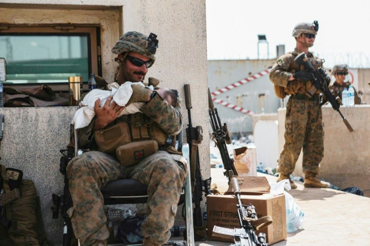 US Central Command Public Affairs issued photos of troops caring for Afghan children amid evacuation efforts at Hamid Karzai International Airport in Kabul
