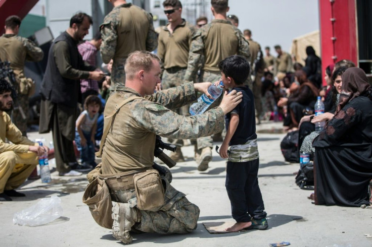 Photos of US troops helping Afghan children were a step away from the chaotic scenes beemed out from the Kabul in the aftermath of the Taliban seizure of the city on Sunday