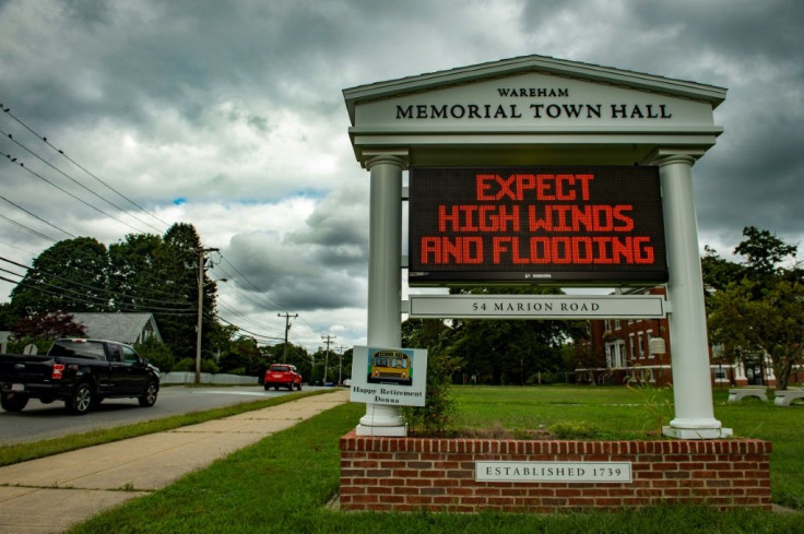 A sign outside the local Town Hall warns people to prepare for high winds and flooding ahead of Tropical storm Henri