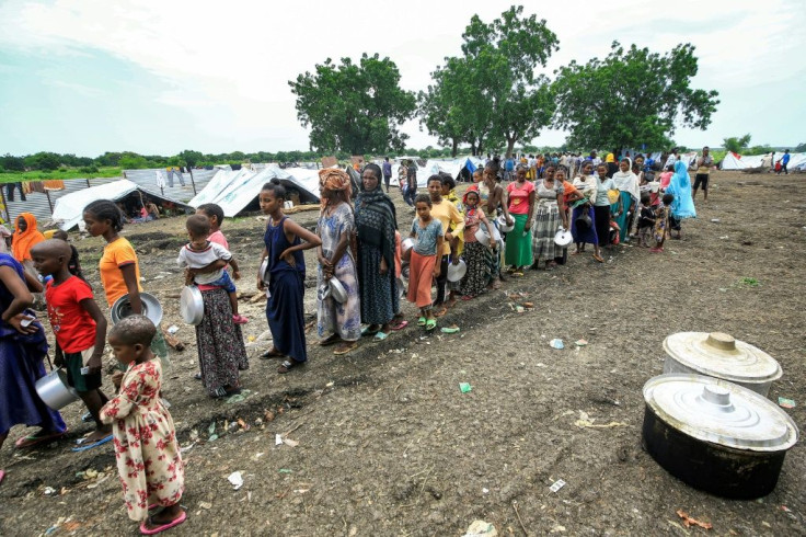 Ethiopian refugees from the Qemant ethnic group queue for food at a camp in Sudan, with officials saying they are expecting more to come