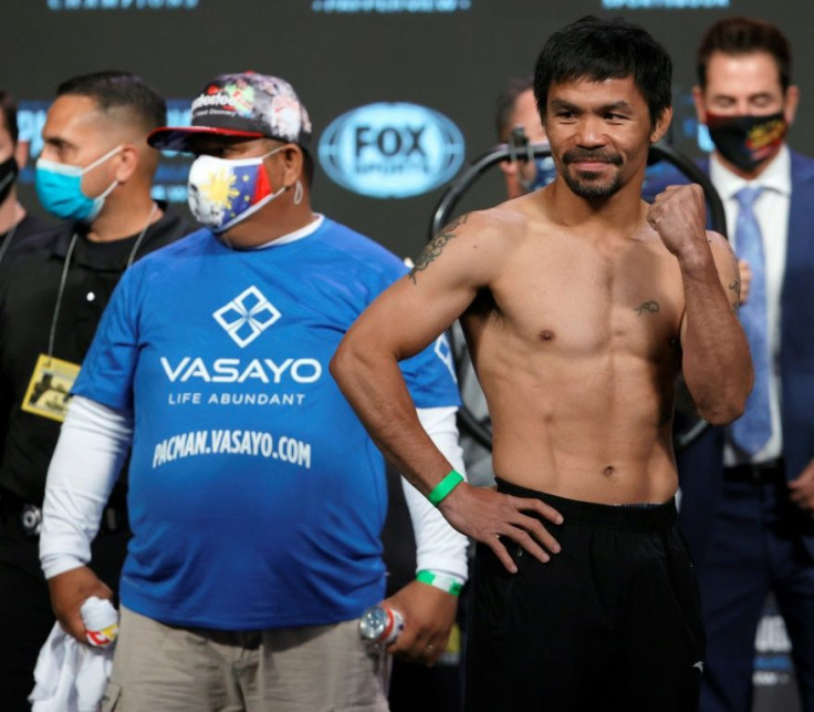 Filipino boxing star Manny Pacquiao poses onstage during the weigh-in at MGM Grand Garden Arena ahead of his WBA welterweight fight against Yordenis Ugas