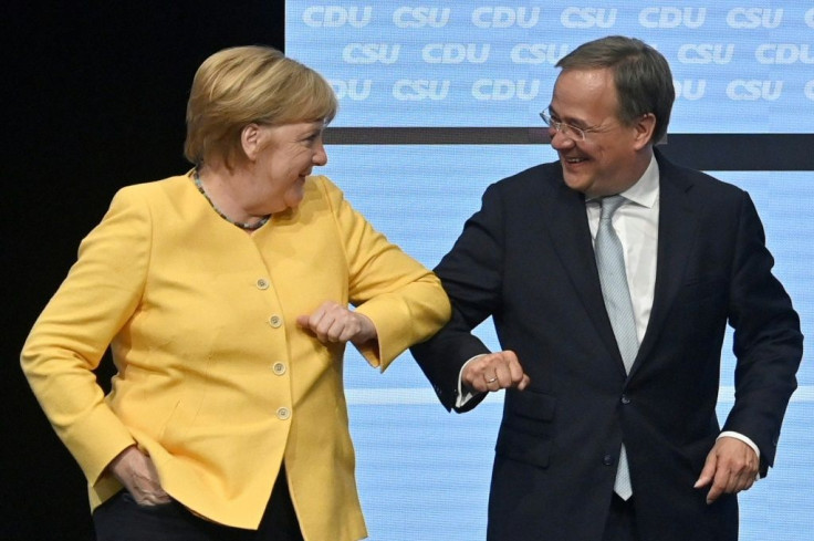 German Chancellor Angela Merkel bumps elbows with would-be successor Armin Laschet at an election rally in Berlin