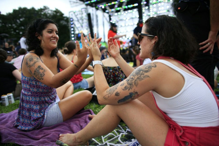 Groups of revelers cheered and danced, snagging spots by laying down picnic blankets ahead of five hours of live music that kicked off at 5 pm (2100 GMT)