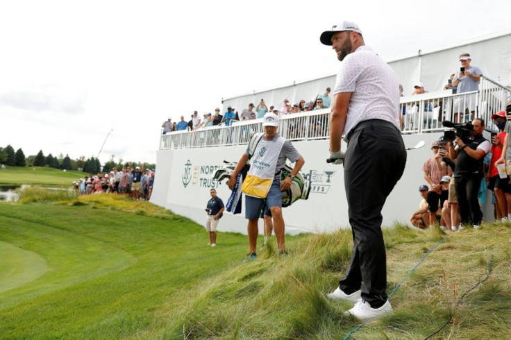 Top-ranked Jon Rahm of Spain watches his shot from the rough at the par-5 13th hole in Saturday's third round of the US PGA Northern Trust tournament