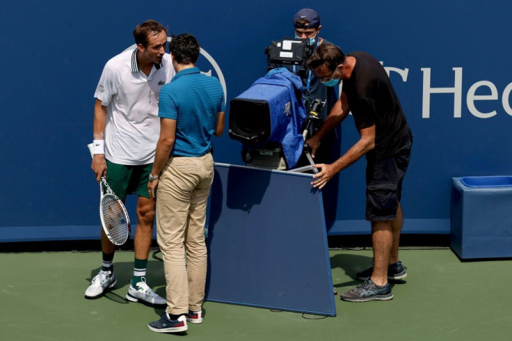 Top-seeded Russian Daniil Medvedev of Russia speaks to chair umpire Nacho Forcadell after colliding with a television camera in his semi-final loss to Andrey Rublev at the ATP Cincinnati Masters