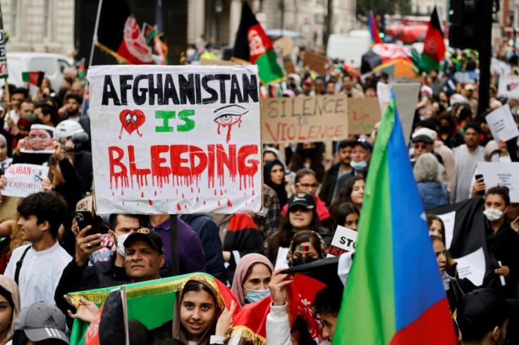 Protesters in London carry placards and wave Afghan flags as they march in solidarity with the people of Afganistan