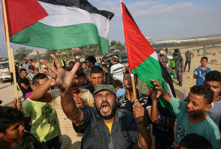 Palestinians protest near the border fence with Israel, east of Gaza City, to denounce the Israeli siege of the Palestinian enclave and express support for Jerusalem's Al-Aqsa mosque, on August 21, 2021