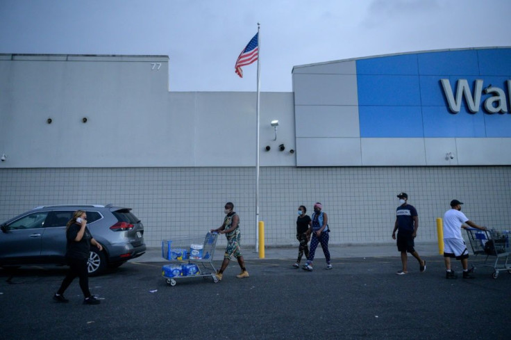 Shoppers exit a department store as tropical storm Henri approaches in Westbury, Long Island on August 21, 2021