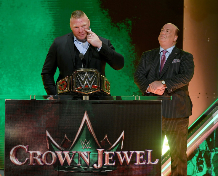 WWE champion Brock Lesnar (L) speaks during a WWE news conference as his advocate Paul Heyman