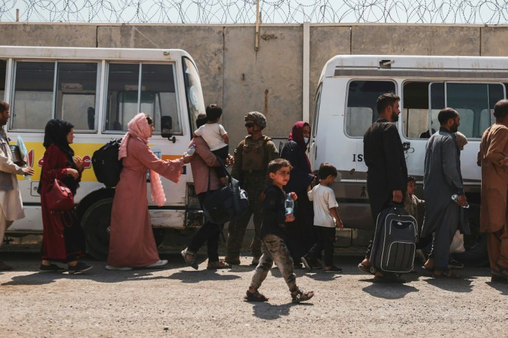 In this image courtesy of the US Marine Corps, evacuees load on to buses to be processed during an evacuation at Hamid Karzai International Airport, Kabul, Afghanistan, August 22, 2021