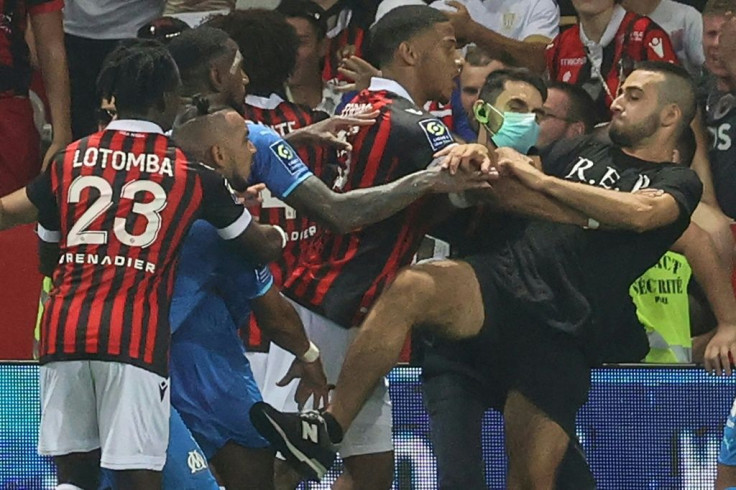 Dimitri Payet (2nd L) is involved in the melee that ensued after he was struck by a bottle thrown from the crowd