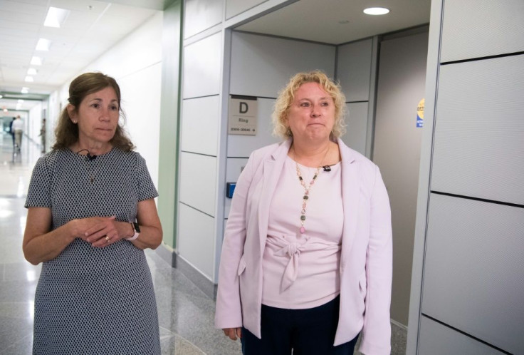Karen Baker (R) and Elaine Kanellis stand near where they were working in the Pentagon when a hijacked jetliner crashed into the building on September 11, 2001