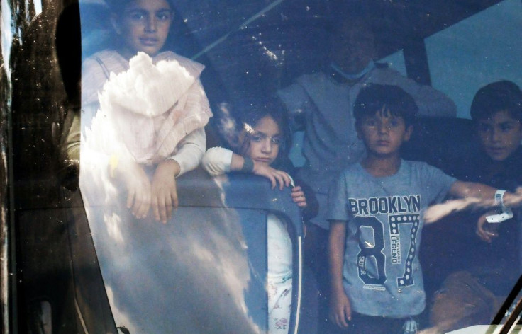 Afghan refugees arriving on a bus at a resettlement center in Chantilly, Virginia