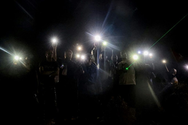 Palestinians use their phones to protest in Beita against the Eviatar outpost. All settlements are considered illegal under international law