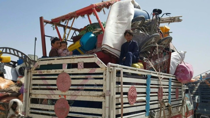Around 200 Afghan refugees who fled their country before the Taliban took control gather at the Pakistan border with Afghanistan as they wait to follow the required procedures to be allowed to cross. "We emigrated from Afghanistan during bombing and hards