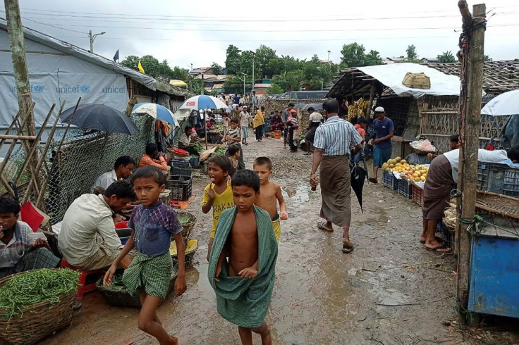 Rohingya refugees walk along a path at Kutupalong refugee camp in Ukhia, Bangladesh
