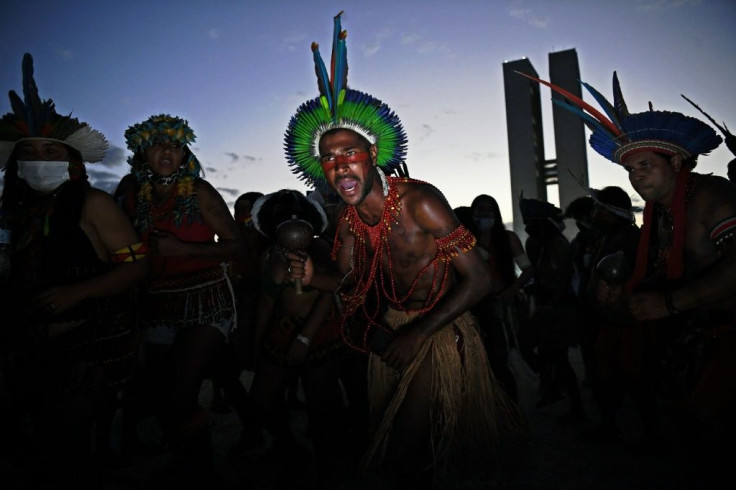 Indigenous men are seen during a protest outside the Supreme Court building in Brasilia, on August 24, 2021