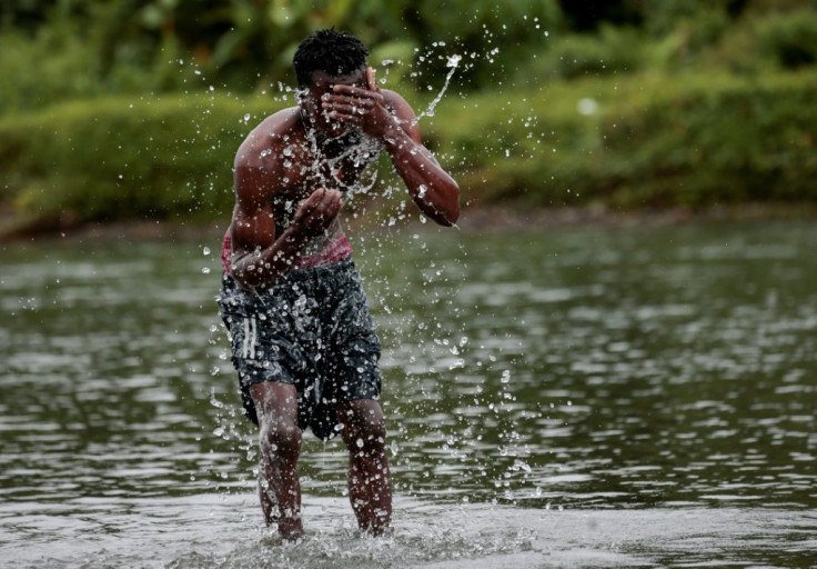 A migrant washes himself in the Tuquesa River after arriving in Bajo Chiquito, Panama having crossed the Darien Gap from Colombia Migrantes de HaitÃ­ y otros paÃ­ses llegan a territorio panameÃ±o, luego de caminar durante cinco dÃ­as por el TapÃ³n del Dar
