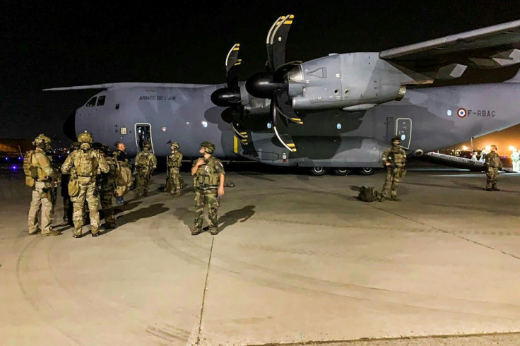 French soldiers stand close to a military plane at Kabul airport