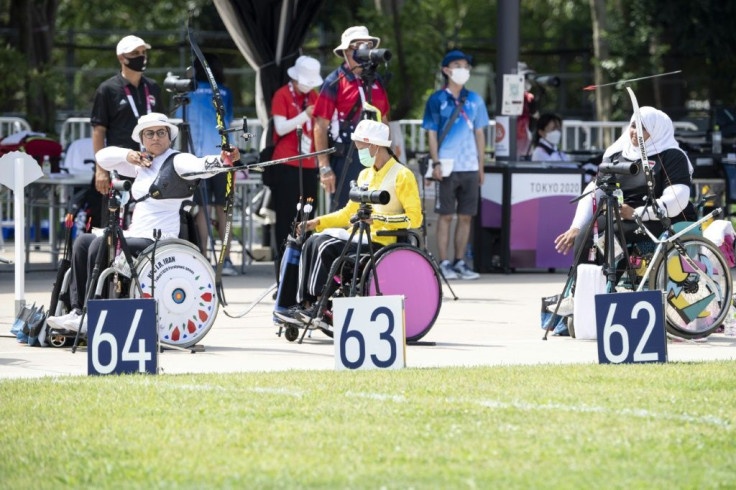 Iran's Zahra Nemati (L) shots an arrow in the women's individual ranking round during the Tokyo 2020 Paralympic Games at Yumenoshima Park Archery Field in Tokyo