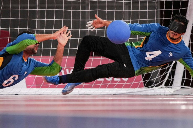 Brazil's Leomon Moreno (R) and Romario Marques defend a ball during the goalball preliminary (group A) match against USA at the Tokyo 2020 Paralympic Games